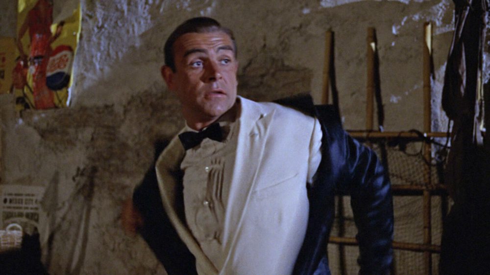 Connery in Goldfinger where James Bond unzips his wetsuit to reveal his black tie attire