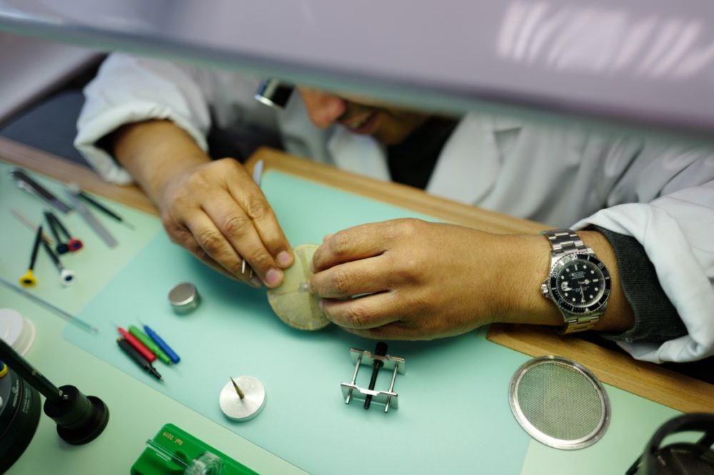 Man dismantling and servicing a watch