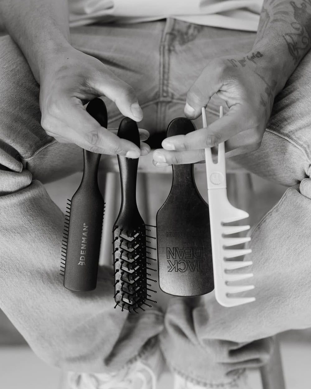A wide-tooth wooden comb resting on a bathroom shelf
