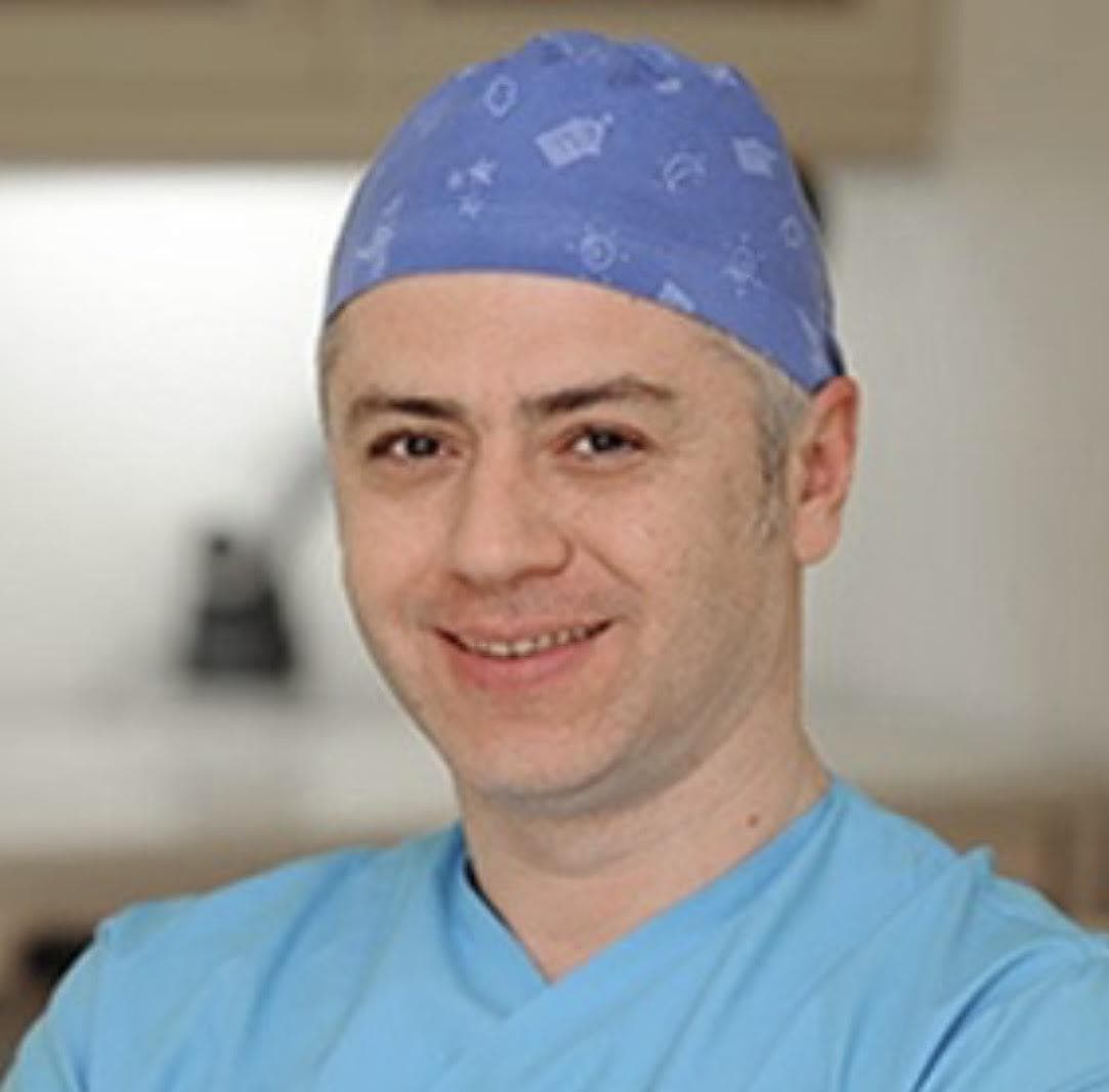 A person wearing a blue scrubs and a blue cap AI-generated content may be incorrect.